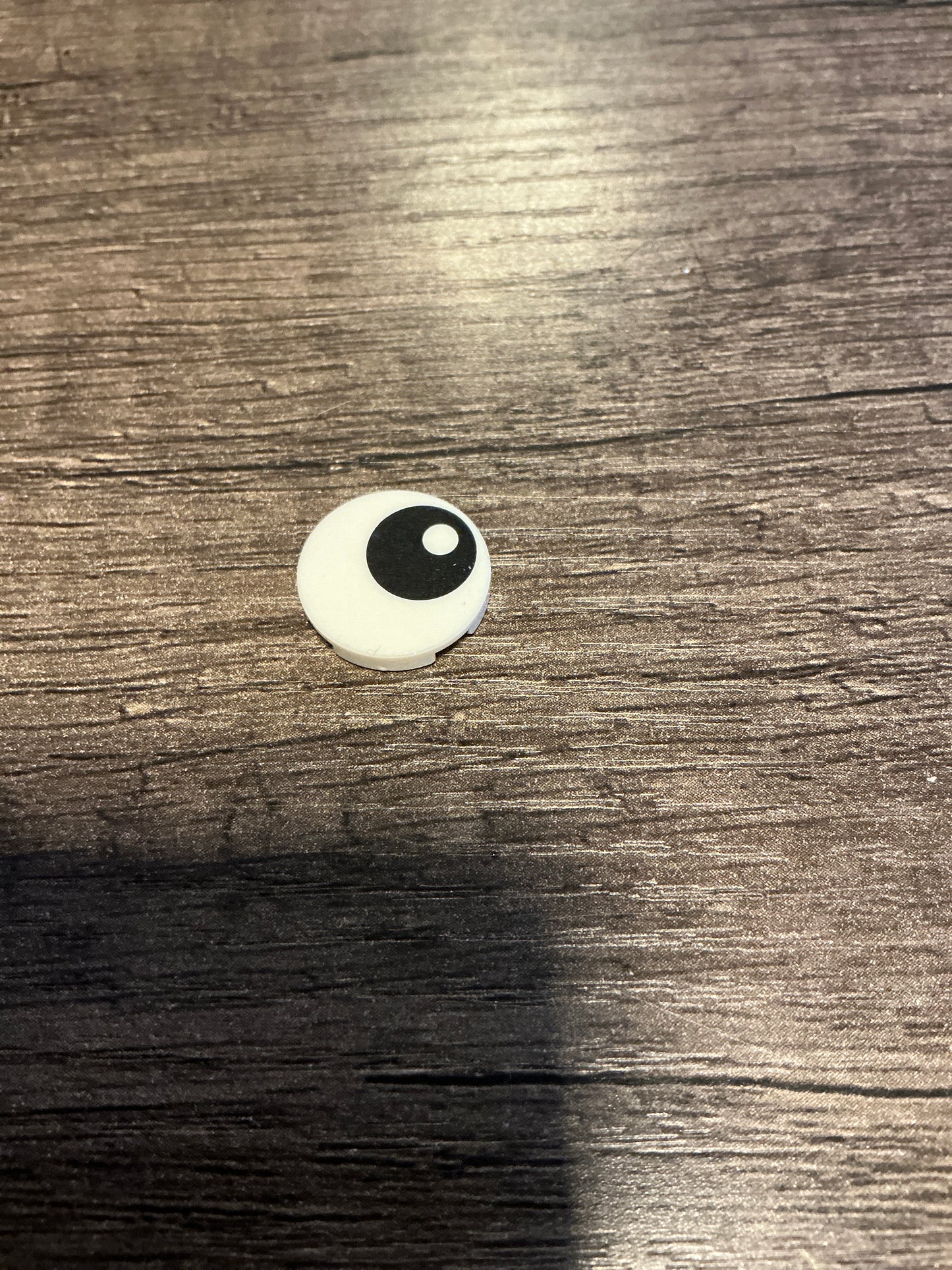 Tile, Round 2 x 2 with Bottom Stud Holder with Black Eye with Pupil Pattern